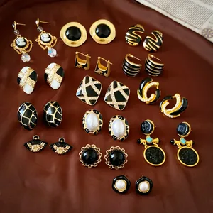 Collection of luxury vintage style black and gold enamel earrings with elegant pearl accents