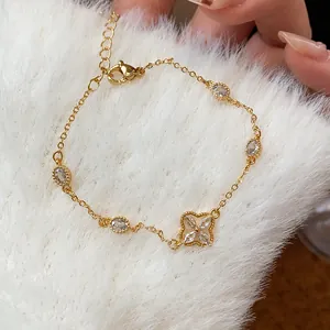 Detailed view of elegant gold flower bracelet with sparkling zircon stones on white fur background