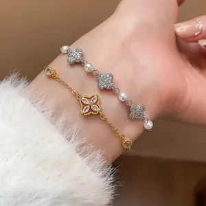 Close-up detail of a delicate zircon flower pearl bracelet worn on a female wrist