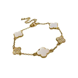 Elegant gold-plated clover charm bracelet with crystal and acetate flower inlays