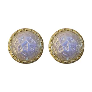Elegant irregular geometric round stud earrings with iridescent blue texture and gold frame.