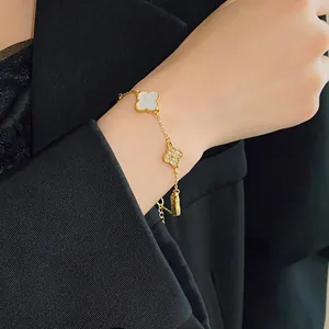 Detailed shot of gold-plated clover bracelet with acetate and rhinestone charms