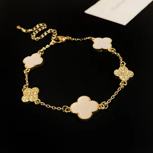 Detailed view of a gold clover bracelet with acetate and rhinestone petals.