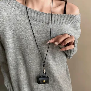 Miniature black leather pouch necklace on long cord, stylish coin bag sweater chain accessory