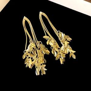 Elegant gold leaf tassel earrings featuring delicate wheat ear designs on black background