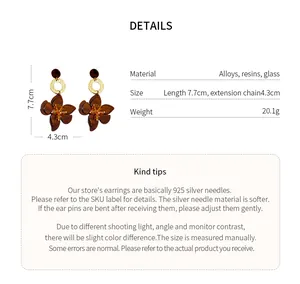 Detail view of resin flower earrings showing dimensions 7.7cm by 4.3cm and material specifications