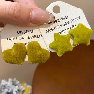 Detail view of olive green flocked heart and star stud earrings with S925 silver needles.