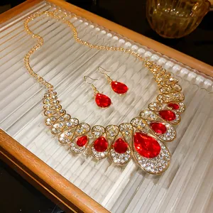 Detail showing red teardrop rhinestone necklace and earring jewelry set on decorative tray
