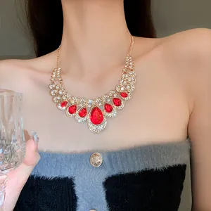 Macro detail of luxury statement necklace with sparkling red teardrop rhinestones