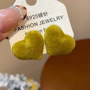 Macro view of cozy moss green flocking heart stud earrings with S925 silver needle detail