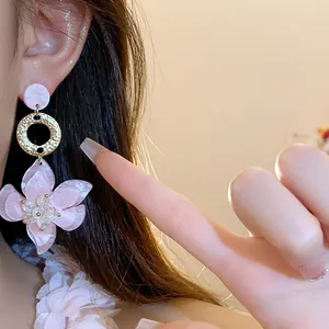 Detail view showing the intricate texture of elegant pink resin flower drop earrings