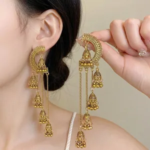 Elegant vintage court style gold tassel jhumka earrings worn by an Asian female model