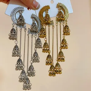 Detailed view of vintage bohemian style long tassel earrings in gold and silver finish
