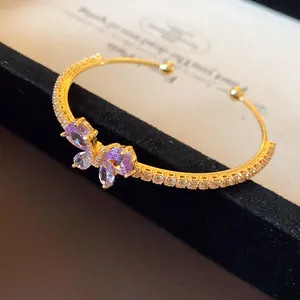 Magnifique bracelet jonc doré orné d'un charmant papillon en zircon violet brillant