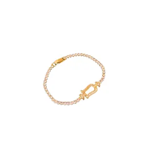 Elegant gold horseshoe clasp bracelet with sparkling zircon stones in a minimalist style