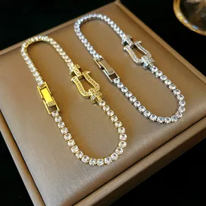 Detailed macro view of elegant horseshoe buckle zircon bracelets in gold and silver tones