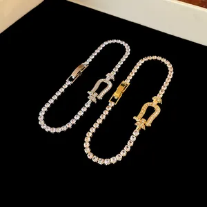 Detailed view of cubic zirconia horseshoe buckle tennis bracelet in gold and silver
