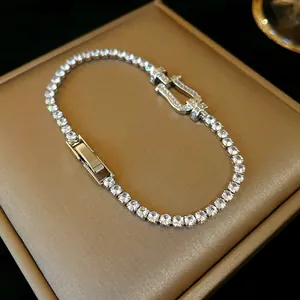 Close-up detail of luxury silver zircon bracelet featuring a distinctive horseshoe buckle