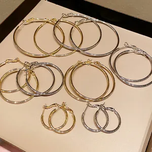 Detailed view of gold and silver minimalist hoop earrings in various sizes for women