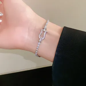 Close-up detail of a silver zirconia horseshoe buckle bracelet worn on a wrist