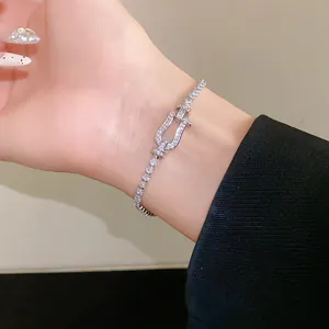 Detail view of a luxury horseshoe buckle bracelet with sparkling pavé cubic zirconia
