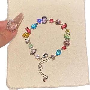 Multicolor zircon bracelet with teardrop and square crystals on a delicate silver chain.