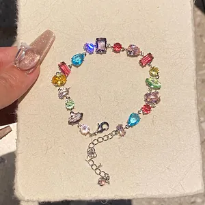 Close-up view of a vibrant colorful zircon bracelet featuring mixed gemstone cuts and shapes