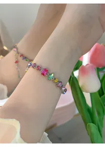 Close-up of elegant colorful zircon bracelet featuring mixed cut stones on a female wrist