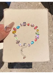 Detail view of a vibrant colorful zircon bracelet with mixed gemstone shapes on a white card.