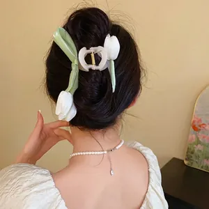 Elegant white tulip flower hair claw clip shown on model for a sweet style