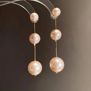 Elegant long drop earrings featuring three graduated pink pearls and s925 silver pins.
