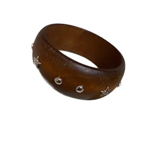 Vintage chunky brown wooden bangle with decorative silver star and round stud accents.