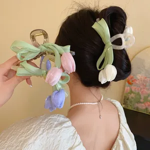 Detailed view of elegant mesh bow and tulip flower claw clips in sweet pastel colors