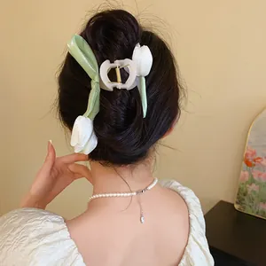 Back view of a mesh tulip claw clip styled in an elegant updo hair arrangement