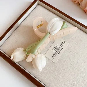 Close-up of fabric tulip flower details on a light peach acrylic hair claw clip