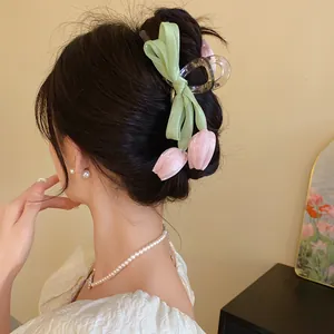 Detail view of sweet Korean style pink tulip and mesh bow hair claw clip for women