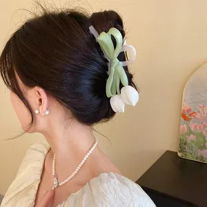 Detail view of sweet mesh bow hair claw clip with elegant tulip flower charms
