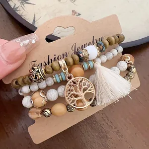 Detailed view of bohemian wood and stone beaded bracelet set with tree of life pendant.