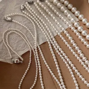 French retro style white beaded pearl necklaces with elegant silver metallic clasps.
