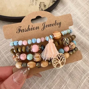 Detailed macro shot of a four-piece bohemian wood and stone beaded bracelet set