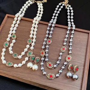 Elegant vintage-style double layer pearl necklace and earring set with rhinestone accents