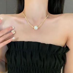 Elegant French baroque pearl pendant necklace with double-layered gold chain for women.