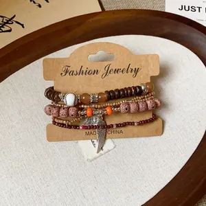 Detail of retro bohemian multi-layered wooden beaded bracelets on a display card.