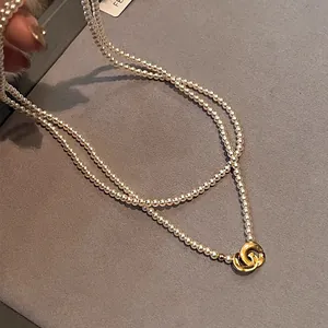 Close-up of elegant double-layer pearl necklace with vintage gold intertwining clasp