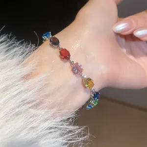 Close-up macro view of a colorful oval-cut zircon bracelet with vibrant gemstone details