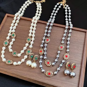 Detailed view of vintage double-strand pearl necklaces and matching drop earrings on tray