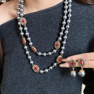 Vintage style grey pearl necklace and earring set featuring red crystal embellishments.
