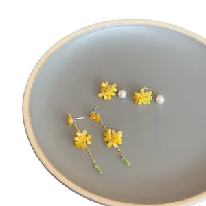 Elegant yellow osmanthus petal earrings with pearl studs and long green tassel drops