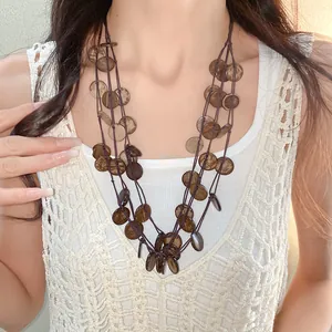 Detailed view of irregular coconut shell pieces on multi-strand ethnic necklace