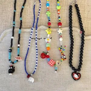 Set of four colorful cartoon beaded necklaces with cute animal and heart pendants